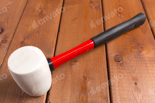 Preview: Mallet rests on wooden table next to workshop tools and supplies