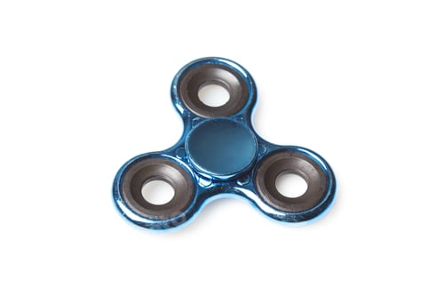 Preview: Fidget spinner with blue color sits on a white background during a still moment