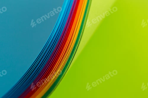 Preview: Colorful sheets of paper in a curved shape on a blue and green background