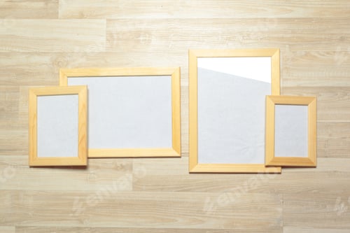 Preview: Different picture frames arranged on a wooden surface for display or decoration