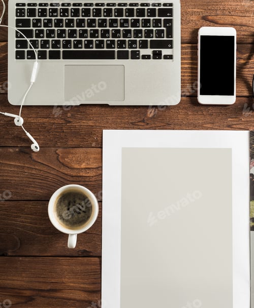 Preview: Laptop and coffee cup sit on wooden table with smartphone and blank paper near them