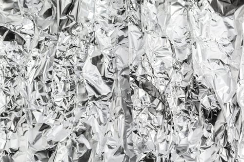 Preview: Crumpled aluminum foil forms a shiny, textured surface in indoor light