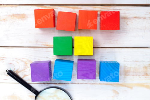 Preview: Building shapes with colorful blocks on a wooden table during a playtime session