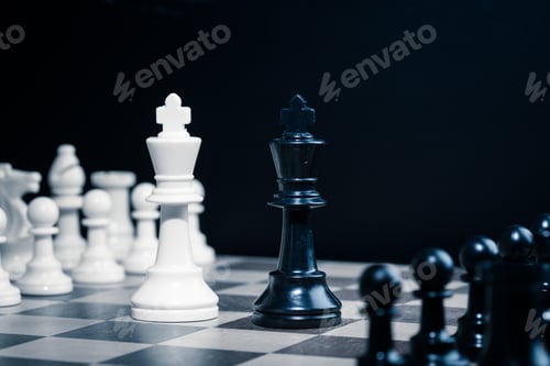Preview: Two kings face each other on a chessboard in a dark setting during a game