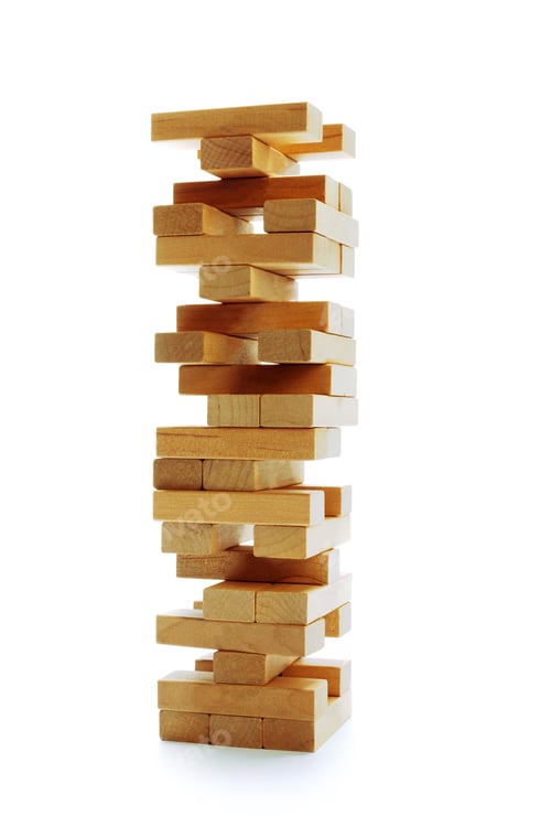 Preview: Wooden blocks stacked in a tower at a game night gathering in a living room setting