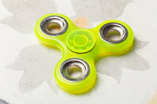 Preview: Bright green fidget spinner on a light background with leaf pattern