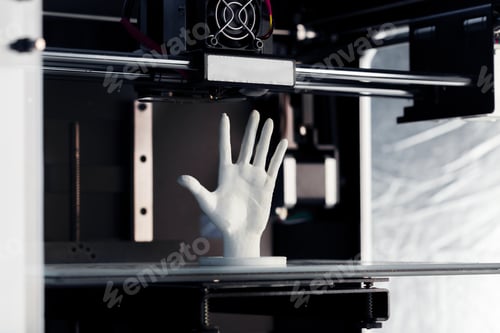Preview: 3D printer creates a small hand model during the printing process in a workshop