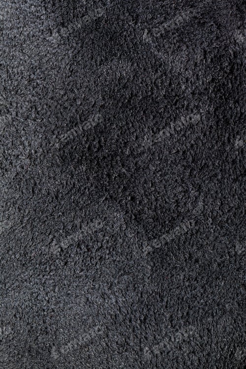 Preview: Black textured fabric on a surface with soft fibers in a close-up view