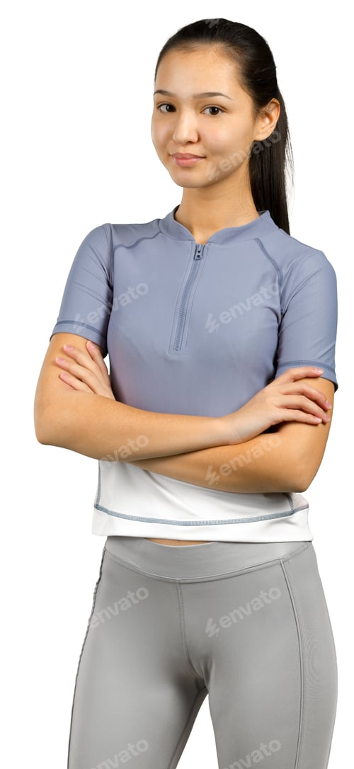 Preview: Young person stands with arms crossed in casual sportswear, showing confidence indoors