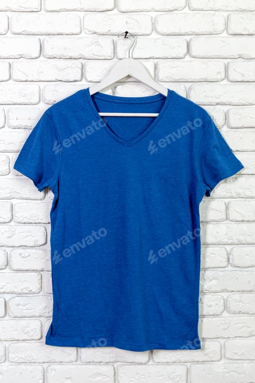 Preview: Shirt hanging on a white wall with brick pattern in bright light