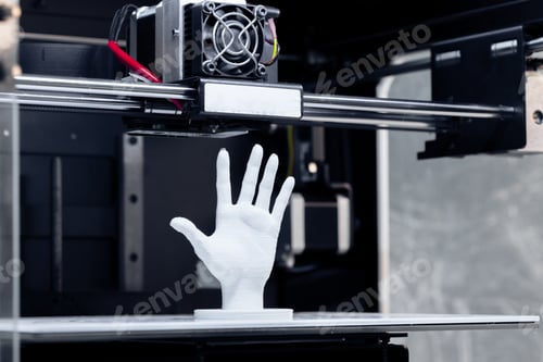 Preview: 3D printer creates a hand model in a workshop setting during the daytime