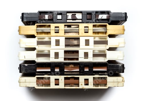 Preview: Vintage cassette tapes stacked in a neat arrangement on a plain background