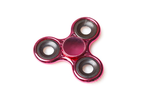 Preview: Fidget spinner sits on a table with a simple design and bright color under good lighting