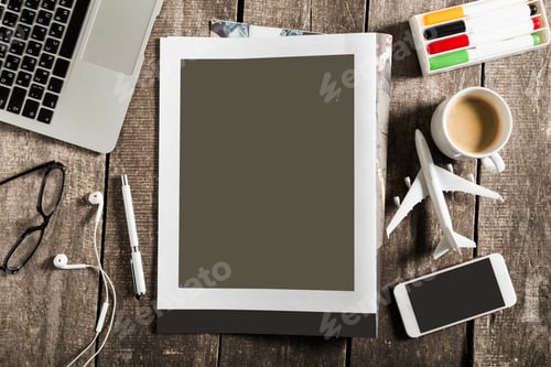 Preview: Workspace with laptop, coffee, and travel items during a creative session in daylight