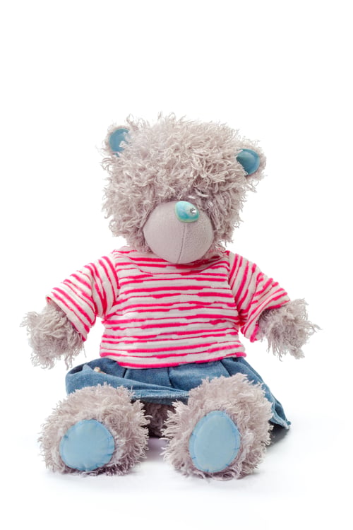 Preview: Soft teddy bear with striped shirt and denim shorts sitting on white background