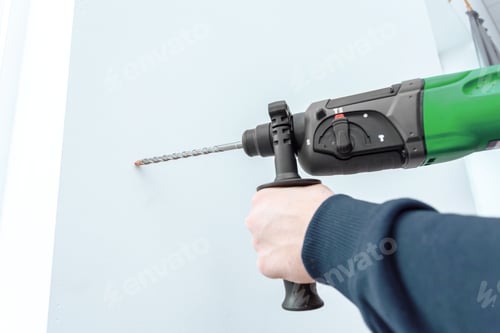 Preview: Drilling a hole in a wall with a power tool for home improvement project