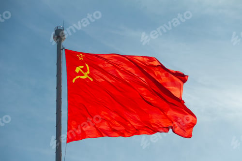Preview: USSR flag waving on flagpole against blue sky