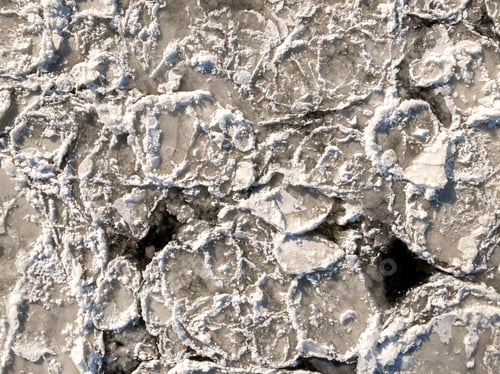 Preview: Top down view of frozen floes on river in winter.