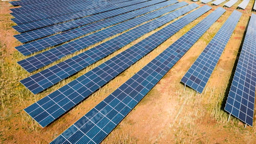 Preview: Aerial view of solar photovoltaic panels on green field
