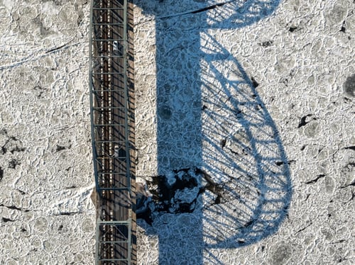 Preview: Traffic on bridge over a frozen river with ice floes.