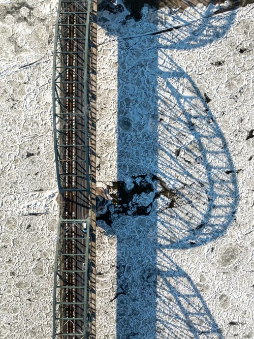 Preview: Traffic on bridge over a frozen river with ice floes.