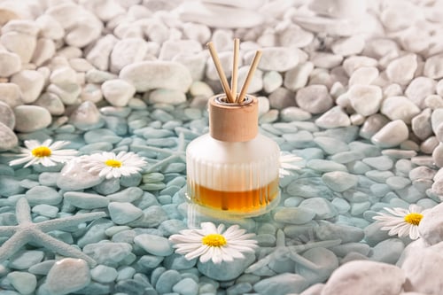 Preview: Aromatic diffuser fragrance on the shore of sea ??white stones.