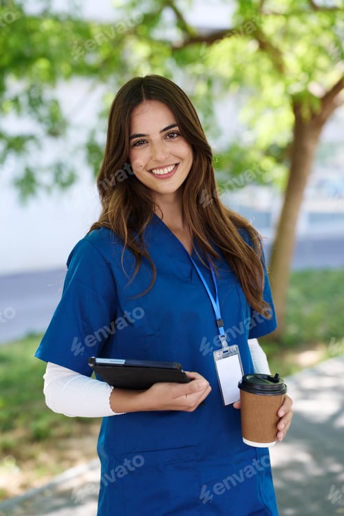 Preview: Healthcare professional holding tablet and coffee cup