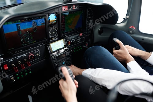 Preview: Pilots operating aircraft controls in modern cockpit during flight training