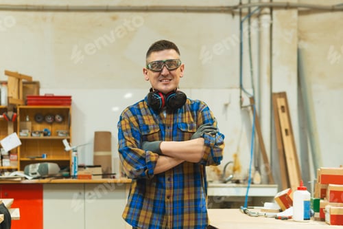 Preview: Carpenter man standing in workshop with arms crossed