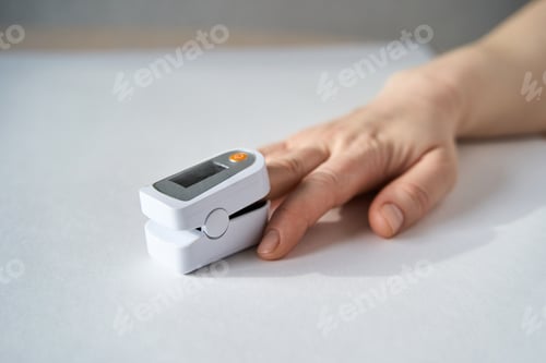 Preview: Hand With Pulse Oximeter Attached To Finger Showing Oxygen Saturation Measurement In Healthcare