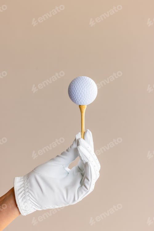 Preview: Woman hand wear white golf glove hold white golf ball wood bamboo tee, Player golfer woman hold golf