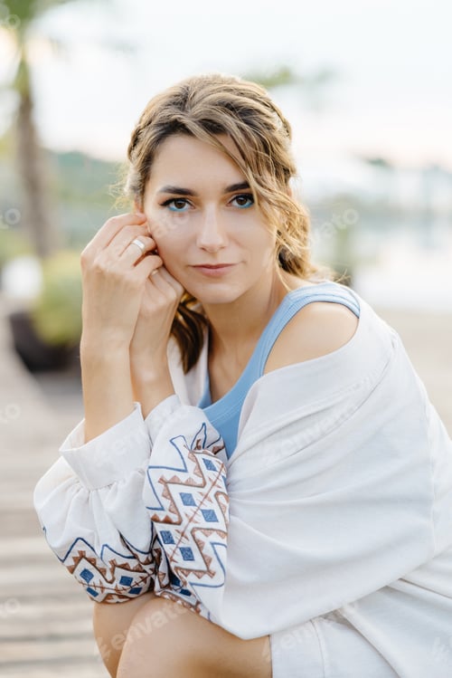 Preview: A Woman Relaxing Under a Palm Tree on a Secluded Dock, Surrounded by the Calming Sounds of the Water