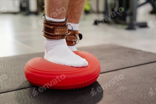 Preview: Person balancing on disc during physical therapy session