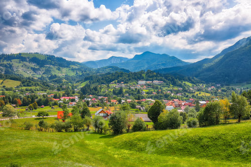 Preview: Amazing alpine landscape with green fields and Piatra Craiului mountains in Dambovicioara Commune.