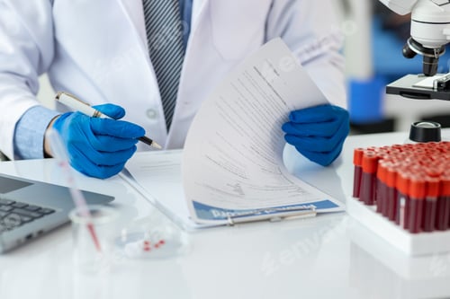 Preview: Scientist analyzing blood test results in a laboratory. Scientist in a lab carefully examines blood