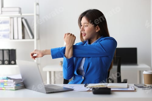 Preview: Asian woman working in office stretching relaxation during break to relieve fatigue.