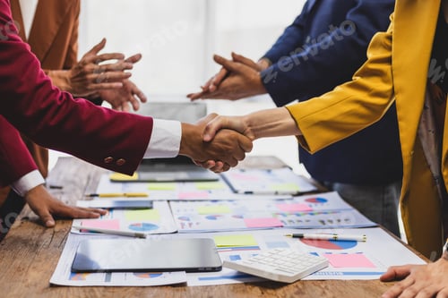 Preview: Business people shaking hands after successful meeting. Two business people shaking hands while thei