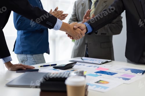 Preview: Business people shaking hands after successful meeting. Two business people shaking hands while thei