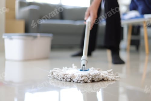 Preview: Cleaner is mopping floors at home with a mop.