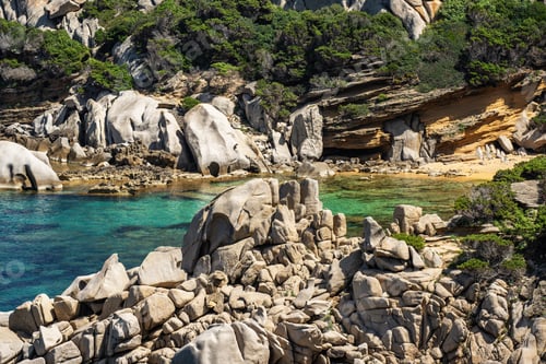 Preview: Rocky shoreline with clear water in Sardynia, Italy during daytime