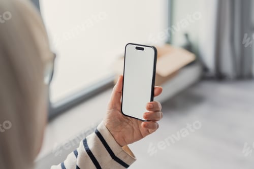 Preview: Person holding smartphone with blank screen mockup