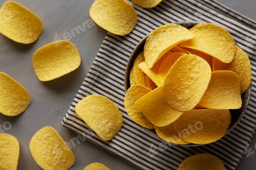 Preview: Unhealthy Cheese and Onion Flavoured Potato Chips in a Bowl, top view.