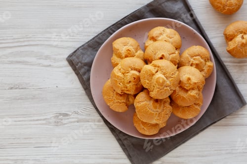 Preview: Homemade Mini Cream Puffs with Whipped Cream Filling on a Plate, top view. Copy space.