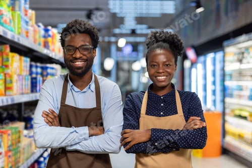 Preview: Happy diverse supermarket workers standing with arms crossed