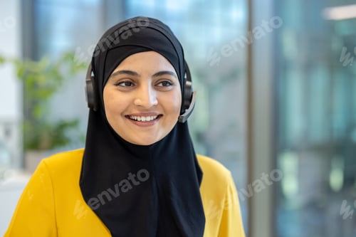 Preview: Smiling muslim customer service representative wearing headset in office