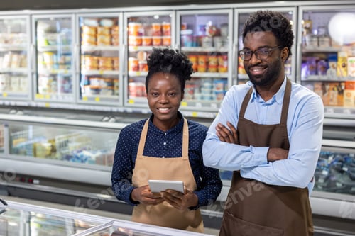 Preview: Supermarket employees working in grocery store frozen food section