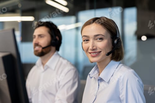 Preview: Call center operator smiling while working in office