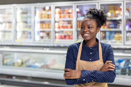Preview: Supermarket employee smiling standing with crossed arms
