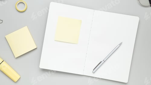 Preview: Tidy workspace featuring notebook, glasses, and stationery fostering productive environment