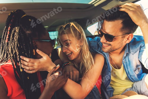 Preview: Three best friends enjoying traveling in the car, sitting in rear seat and having lots of fun on a r